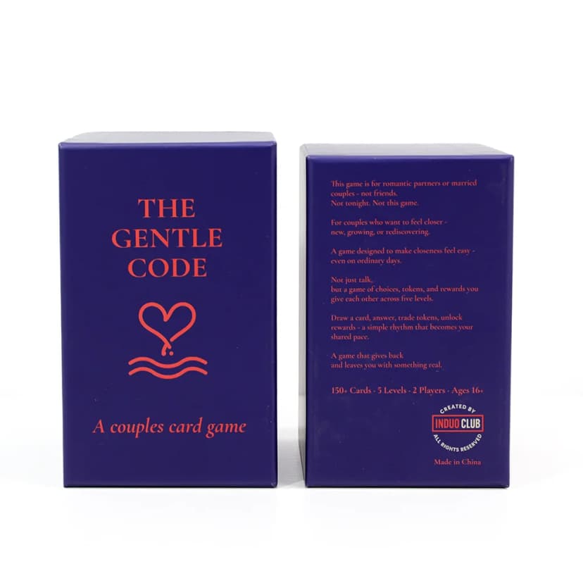 Front and back of The Gentle Code game box showing beautiful navy packaging with coral typography